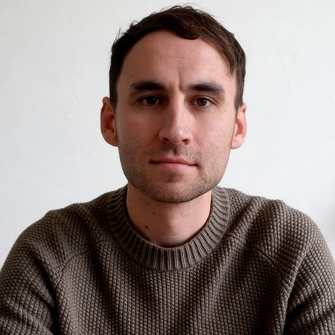 Just Dave, a preset AI streamer in a brown knit sweater against a plain white wall
